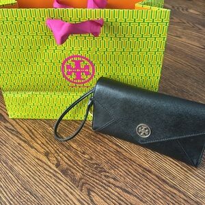 Tory Burch black texture leather golf logo snap flap large wristlet wallet.